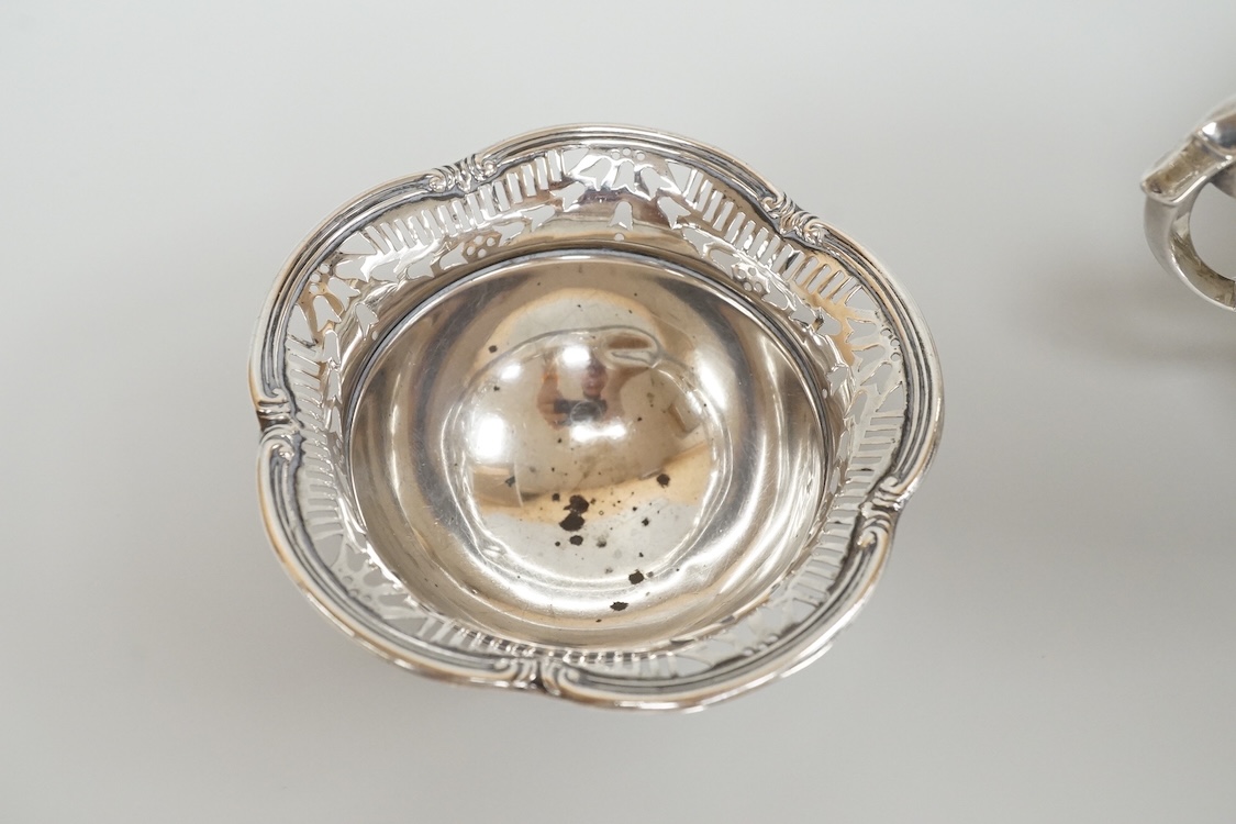 A George V silver mounted capstan inkwell, A & J Zimmerman Ltd, Birmingham, 1913, diameter 11.4cm, together with a small silver bowl, a small silver 'dish ring' salt(a.f.), a silver two handled bowl, a silver pill box an